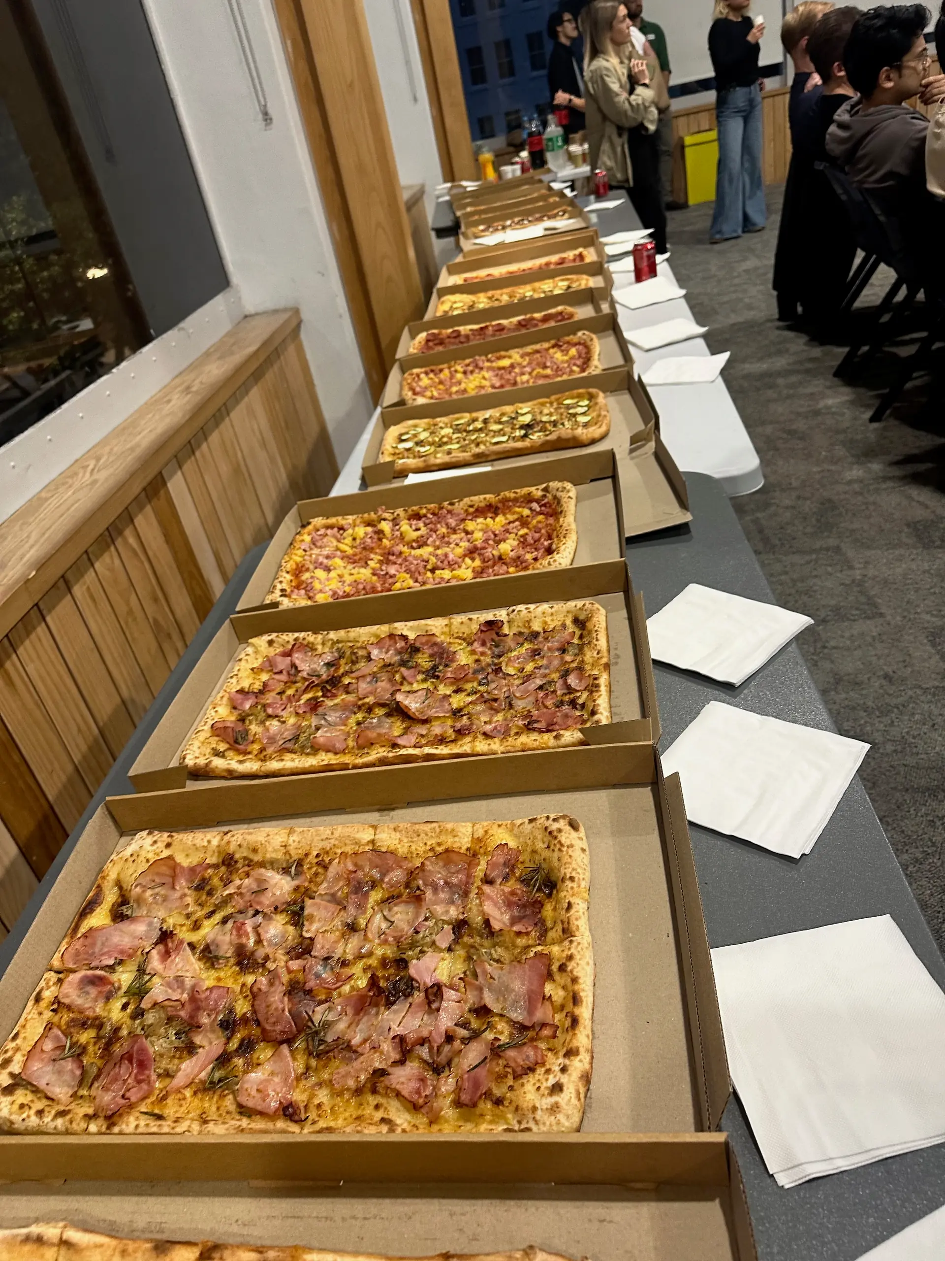 Row of Pizza Presto pizzas laid out for attendees